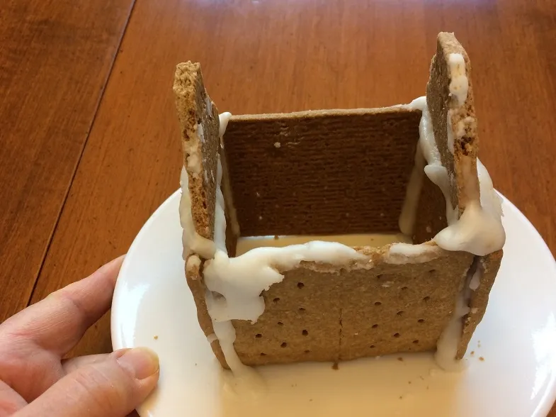 partially built Christmas graham cracker house